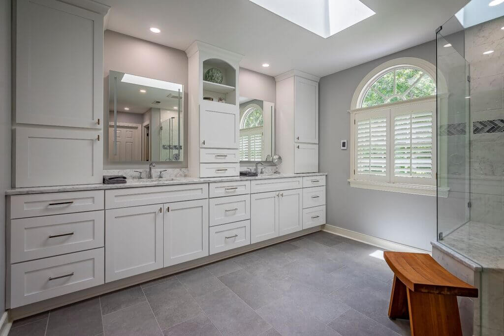 white bathroom with shower and seating area 